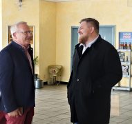 Oberbürgermeister Torsten Ruban-Zeh und Marcus Badke stehen sich im Innenbereich der Seenland Autowerkstatt gegenüber und unterhalten sich.